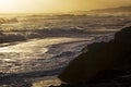 Surf on beach at sunset