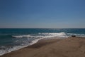 The surf of the blue turquoise sea with white perpendicular wave