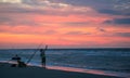 Surf Fisherman on an Ocean Beach at Dawn Royalty Free Stock Photo