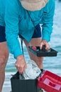 Surf fisherman searching in tackle box Royalty Free Stock Photo