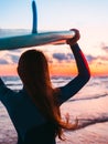 Surf girl with long hair holding surfboard on beach at sunset or sunrise. Surfer and ocean Royalty Free Stock Photo