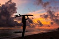 Surf girl meets sunset on the beach. silhouette