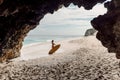 Surf girl with surfboard on ocean beach. Woman with surf board and cave rocks in Bali Royalty Free Stock Photo