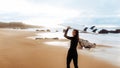 Surf lady going to surfing, woman with surfboard on beach by seaside looking and smiling at camera, panorama, copy space Royalty Free Stock Photo