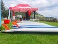 Surf lessons, hire and rentals stand on Mount Maunganui grass beside main-beach