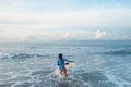 Surf In Ocean. Surfer On Surfboard Swimming In Sea. Surfing Girl In Blue Wetsuit Practicing On Waves.