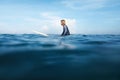 Surf In Ocean. Surfing Man Sitting On White Surfboard. Surfer In Wetsuit In Turquoise Sea.