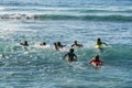 Surf school - several surfboarding students headed into an ocean