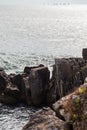 Surf sea rocks with sails on horizone Royalty Free Stock Photo