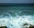 Surf on shores of Indian ocean and overgrown with algae stones