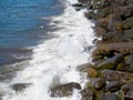 Surf. Waves crash on big rocks. Rocky coast and wave. Powerful coastline. Sea foam. The excitement of the sea Royalty Free Stock Photo