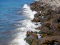 Surf. Waves crash on big rocks. Rocky coast and wave Royalty Free Stock Photo