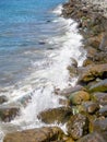 Surf. Waves crash on big rocks. Rocky shore and splashing waves. Powerful coastline. Sea foam. The excitement of the sea Royalty Free Stock Photo