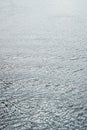 Surface of blue water with small ripples. Not a calm river surface. Vertical background Royalty Free Stock Photo