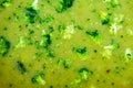 Surface of brocoli soup with pieces, closeup