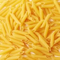 Surface covered with penne pasta Royalty Free Stock Photo