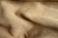 Surface of draped brown corduroy fabric