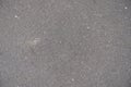Surface of dusty grey asphalt from above