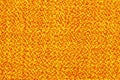 Surface of the fabric is yellow and orange. Bright, colorful background, texture