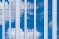The surface of a glass high-rise building with reflection of clouds Royalty Free Stock Photo