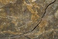 The surface of granite stone with streaks, spots and patterns of different colors. Cracked stone Royalty Free Stock Photo
