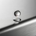 Surface has a linear, textured pattern, highlighting the droplet\'s Royalty Free Stock Photo