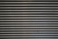 Surface of a latticed metal fence with jagged stripe elements