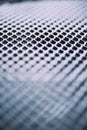 Surface of latticed metal fence. Stainless steel and aluminum light blur background. Macro texture