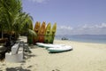 Beautiful beach scenery, kayaks stack on white sandy beach at sunny day Royalty Free Stock Photo