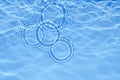 Surface of light blue transparent swimming pool water texture with circles on the water. Trendy abstract nature Royalty Free Stock Photo