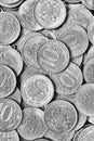 Surface of many Russian coins of 10 rubles close-up. Black and white vertical dramatic illustration. Economy, finance and taxes in