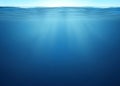 The surface of the ocean or sea is blue, and the underwater part of it is blue, with sun and clouds Royalty Free Stock Photo