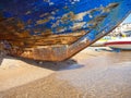 Surface of an old blue boat on a sand in shipyard dry dock Royalty Free Stock Photo