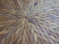 Surface of a placemat or sousplat, made of wood with geometric designs.