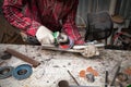 Surface preparation of stainless steel pipes using an angle grinder for further welding in an iron workshop. Industry and