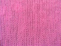 Surface of puce basic knitted fabric in pink Royalty Free Stock Photo