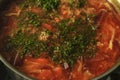 Surface of red Ukrainian borscht cooking with drill close-up top view. Soup with cabbage and beets. Traditional cuisine.