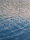 The surface of the river water that looks calm. Only visible ripples - small ripples of water waves blown by the wind. Royalty Free Stock Photo