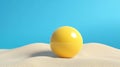 On a surface with a rough texture, a sphere of vibrant yellow is silhouetted against a background of teal Royalty Free Stock Photo