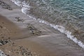 The surface is salty sea water, swaying in small waves near the shore, through the transparent bottom you can see stones Royalty Free Stock Photo