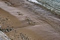 The surface is salty sea water, swaying in small waves near the shore, through the transparent bottom you can see stones Royalty Free Stock Photo