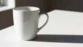 Surface with soft natural light casting a long shadow. The mug has a Royalty Free Stock Photo
