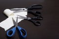 On the surface of the table are three pairs of scissors and a patch of excised tissue.