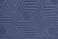 Surface texture with a pattern of dark blue rhombus geometric shapes, background