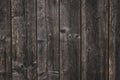 Surface of unrefined gray boards. Texture of dark grey coarse planking. Crude wooden fence. Rough carpentry pine panel. Backdrop o