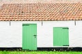 Surface vintage house background with wooden green window open, grung white brick wall and orange concrete roof tiles. Text space