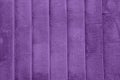 Textured purple concrete wall with vertical lines and stripes as a texture or background. Royalty Free Stock Photo