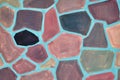 The surface of the wall is painted with paint in the form of a mosaic of colorful irregular polygons