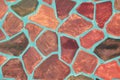 The surface of the wall is painted with paint in the form of a mosaic of colorful irregular polygons