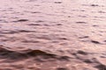 Surface of water with waves background texture, wave close up, light playing on the sea surface, the surface of golden water at Royalty Free Stock Photo